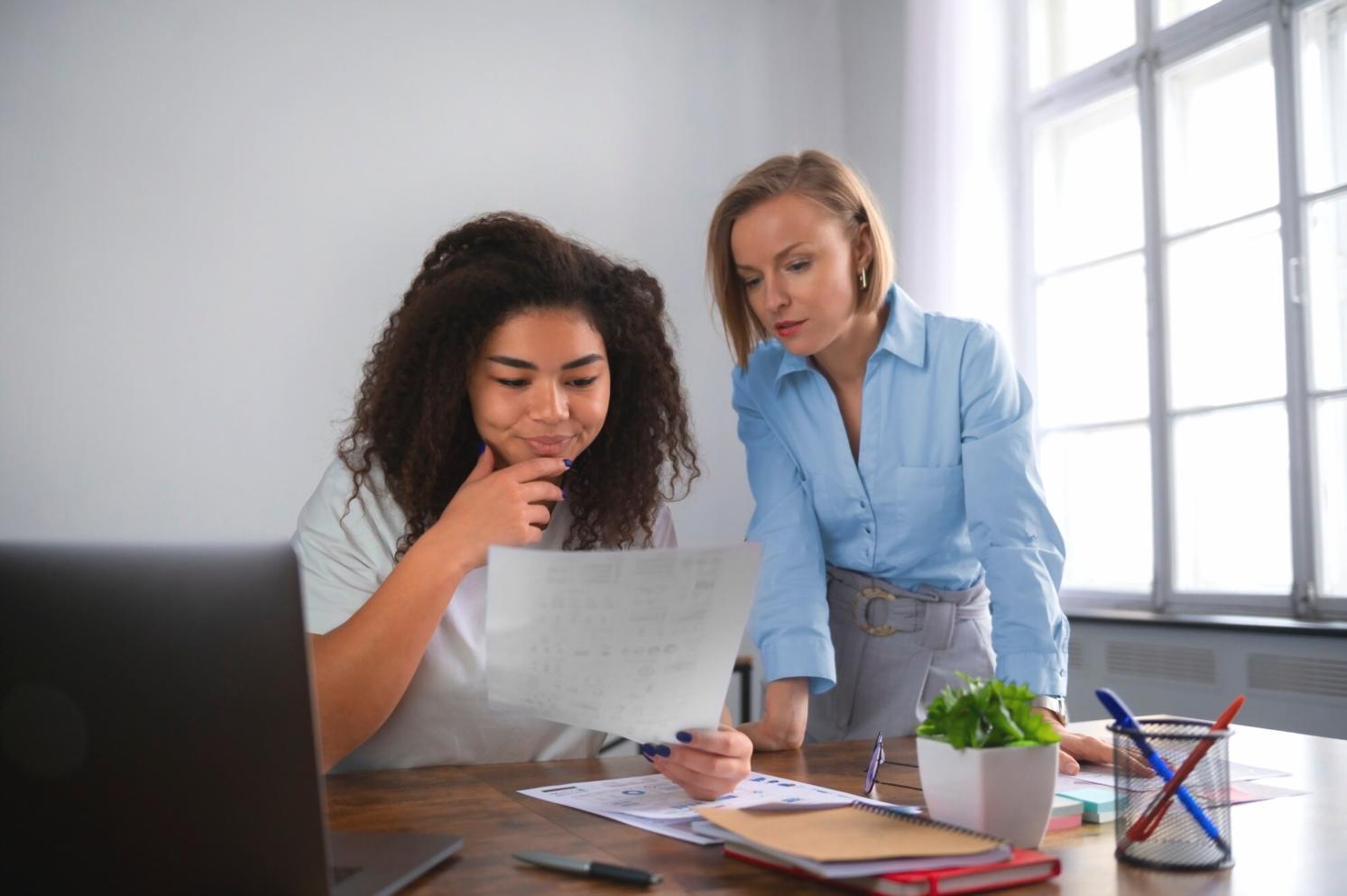 Professional financial planning session with graduates working on real client cases